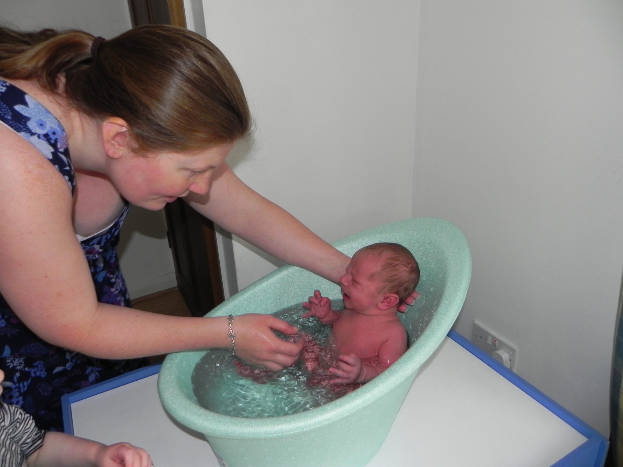 newborn in shnuggle bath